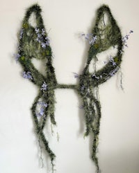 a pair of fairy wings made of moss and flowers